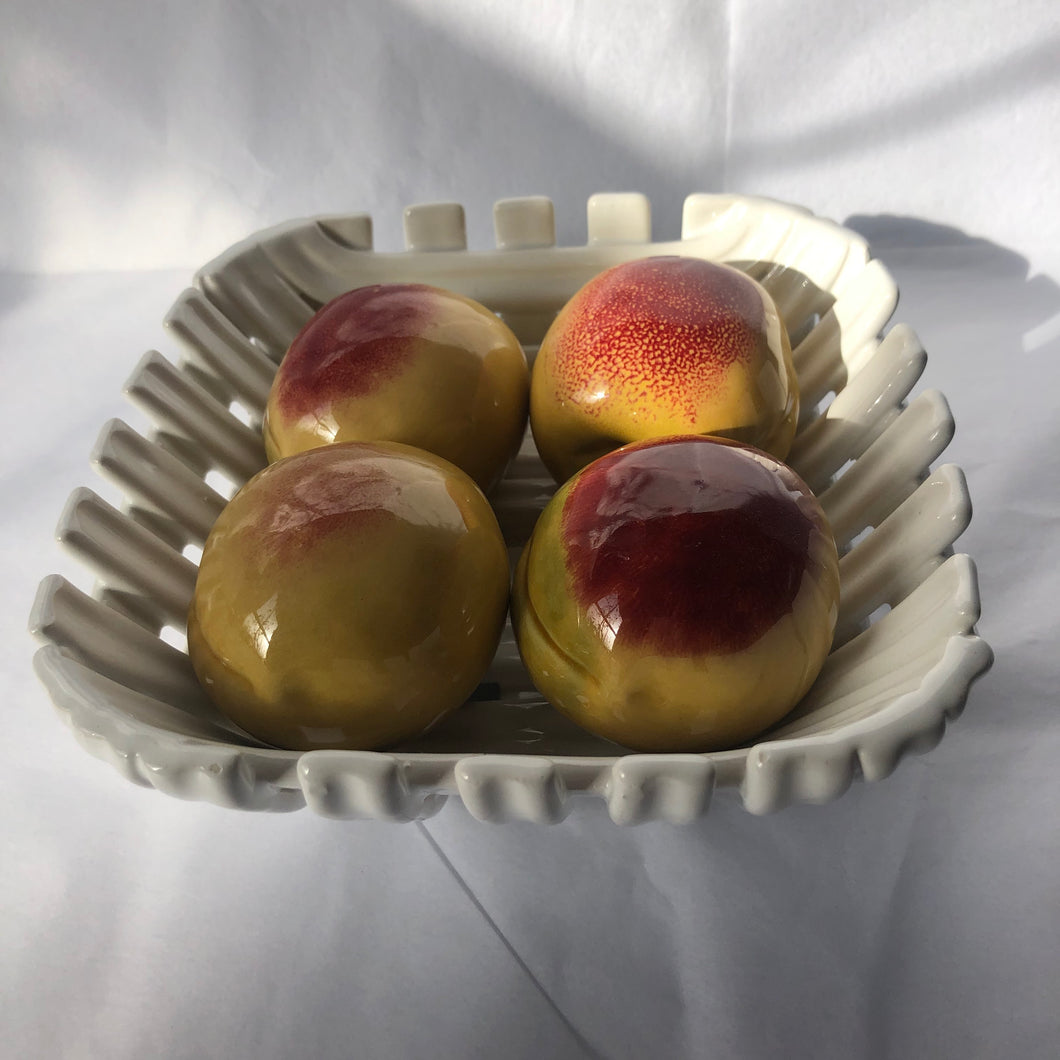 Ceramic peaches in lattice basket